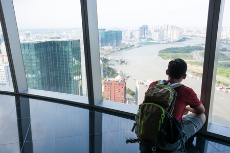 A man sitting to see a view ho chi min city at Vietnamの写真素材