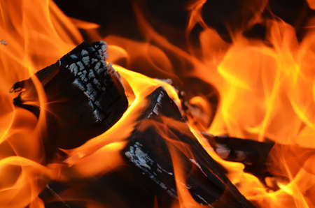 A log burning with a yellow orange flame.の写真素材