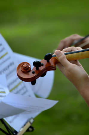 Close up of violin head with music score blowing in the wind.の写真素材