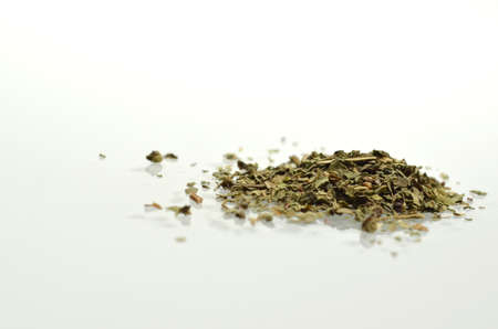 Dried basil isolated and reflected on white background の写真素材