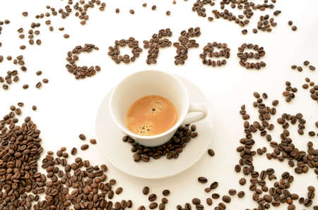 A cup of espresso next to a word の写真素材