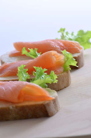 Fish sandwich with smoked salmon, butter and lettuce leaf の写真素材