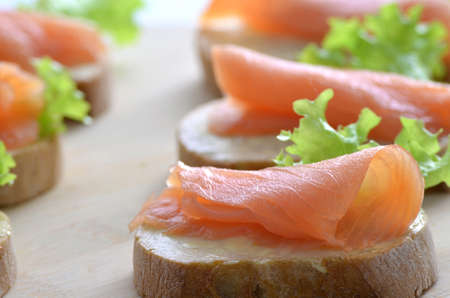 Closeup of a sandwich with smoked salmon, butter and lettuce leaf  Shallow dof の写真素材