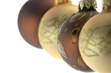 Four brown and golden christmas baubles hanging in  a row  Focus on a second ball の写真素材