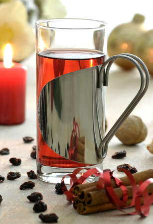 Christmas tea with cinnamon, raisins and other decoration on a wooden background の写真素材