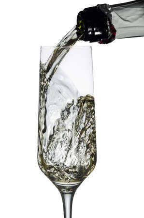 Champagne on a white background being poured into glass の写真素材