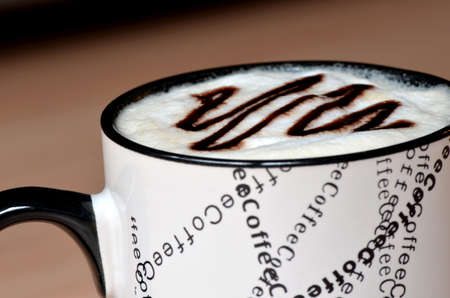 White coffee cup with the word coffee written with black letters  Cream decorated with chocolate の写真素材