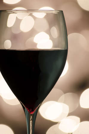 Closeup of a red wine with blurred lights in background の写真素材