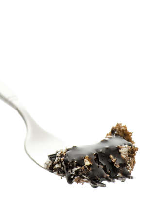 Chocolate cake on a fork decorated with liquid chocolate  Isolated on a white background の写真素材