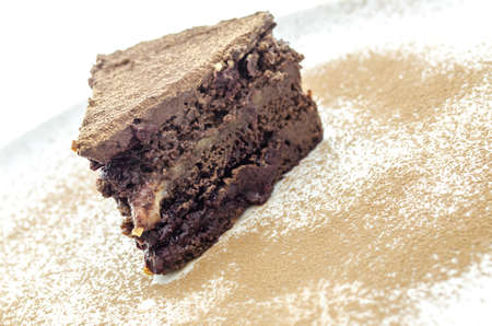 Tasty vegan cake on a white plate decorated with cocoa の写真素材