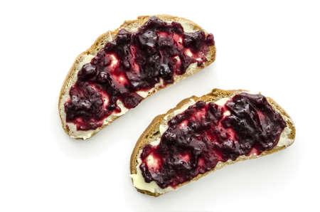 Top view of two pieces of bread with jam and butter isolated on a white background の写真素材