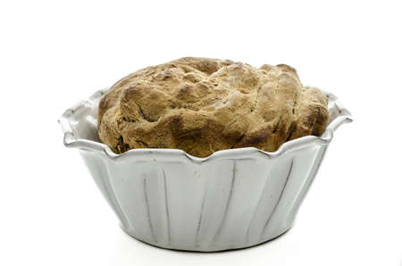 side view of a homemade bread in a baking pan isolated on a white background の写真素材