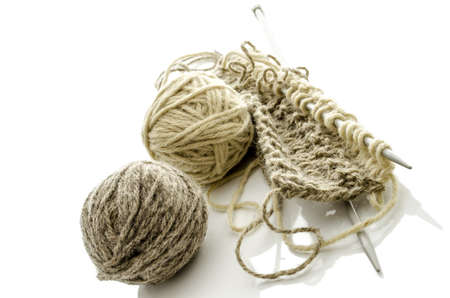 Pattern of knitting with grey ball of woollen thread and needles  Isolated on a white background の写真素材