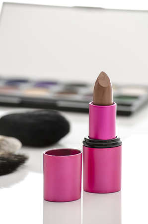 Pink lipstick with blurred cosmetics in background の写真素材