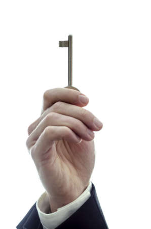 Male hand holding a key  Isolated on a white background の写真素材