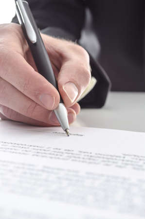 Cropped view of a businessman signing a contract  Shallow focus on signature  の写真素材