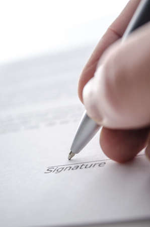 Signing a contract above signature line の写真素材