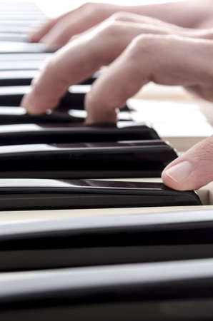 Closeup of male hands playing digital piano の写真素材
