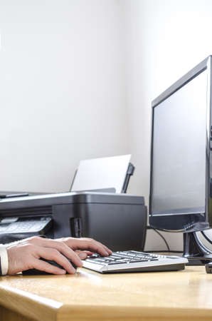 Cropped view of a man working at the office desk の写真素材