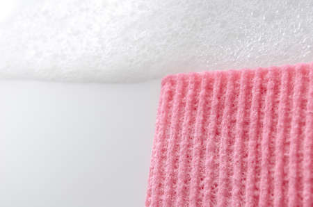 Cropped view of a kitchen sponge and foam representing a cleaning concept の写真素材