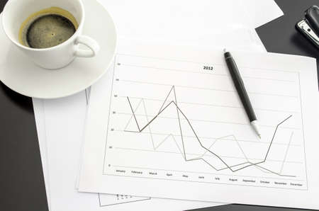 Top view of a graph document on a black office desk の写真素材