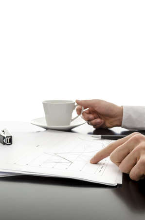 Man showing business documents and drinking coffee の写真素材