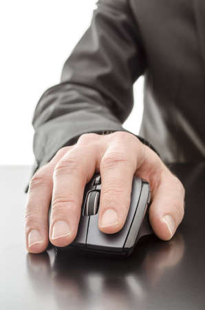Male hand using a computer mouse on a black table の写真素材