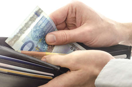 Man taking 20 euro banknote out of his wallet の写真素材