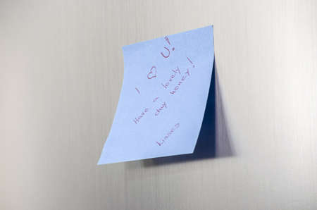 A love you message on a post it note on a stainless fridge の写真素材