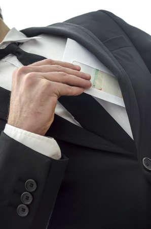 Man putting envelope in his pocket  Metaphor for corruption の写真素材