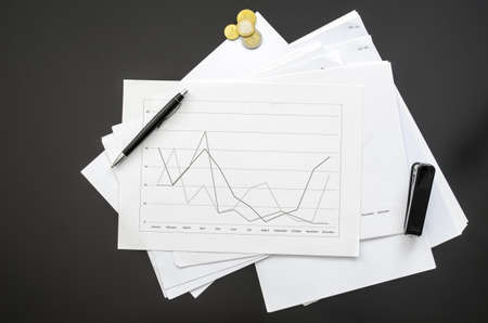 Top view of a graph document on a black office desk の写真素材