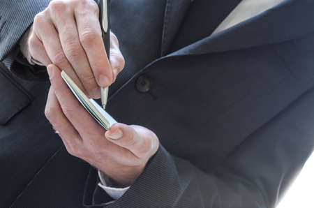 Cropped view of a business man taking notes の写真素材