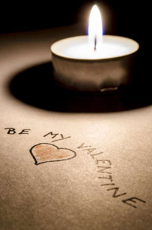 Be my Valentine message and a heart by the candle light の写真素材