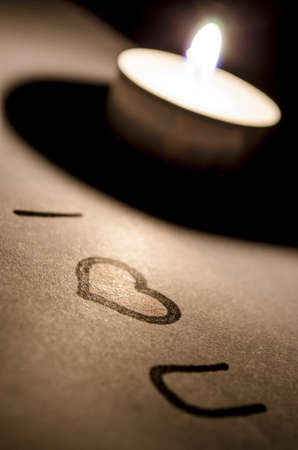 I love you note and a heart by the candle light の写真素材