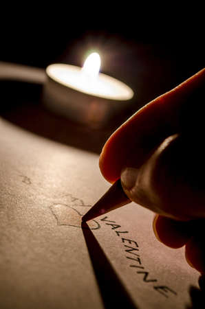 Writing a valentine message  Lovely romantic concept の写真素材