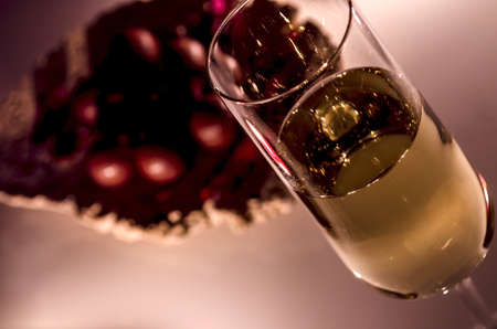 A glass of white wine detail by the candlelight  Represents romantic atmosphere の写真素材