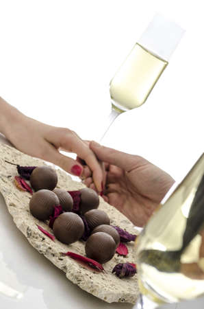 Cropped view of a couple in love holding hands on a white table の写真素材