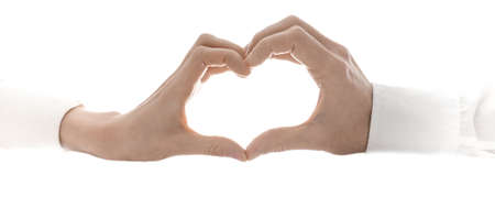 Woman and man making a heart shape  Isolated over white background の写真素材