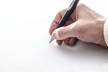 Businessmans hand writing on a blank paper の写真素材