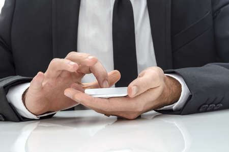 Businessman using  a mobile phone on an office desk の写真素材