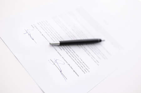 Business contract and a pen  Focus on a signature 