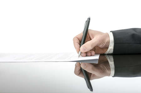 Signing a contract on a black table  With copy space and reflection 