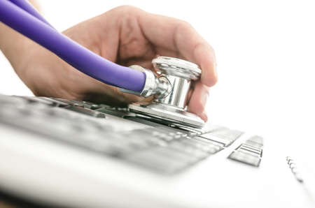 Testing a computer keyboard with stethoscope  Shallow depth of field 