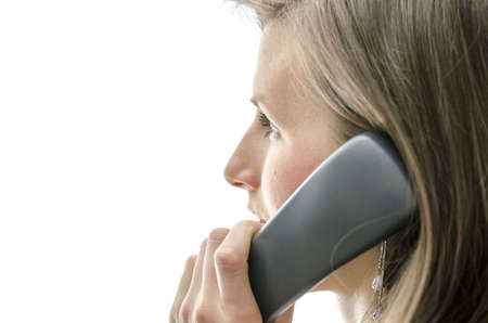 Side view of female call center employee talking on a phone. Over white background.