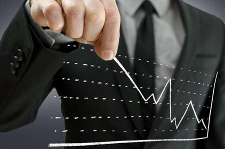 Businessman pulling business graph upwards on a virtual screen  Concept of financial crisis recovery の写真素材