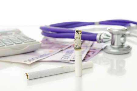 Cigarettes with Euro money, stethoscope and calculator in background  Representing big expenses and...