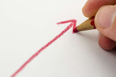 Hand drawn red ascending arrow with hand drawing it  