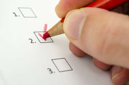 Close up of male hand choosing one of three options の写真素材