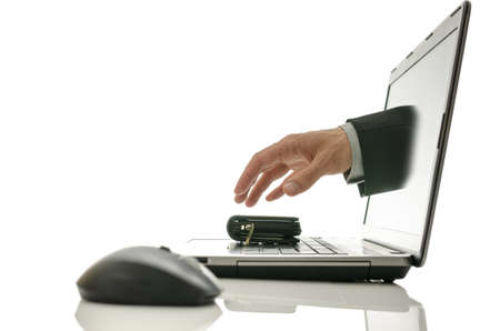 Hand coming out of laptop screen stealing wallet  Concept of internet theft の写真素材
