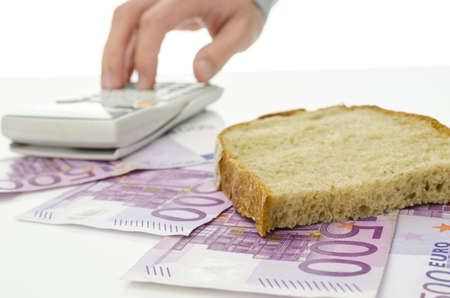 Male hand calculating monthly food costs.の写真素材